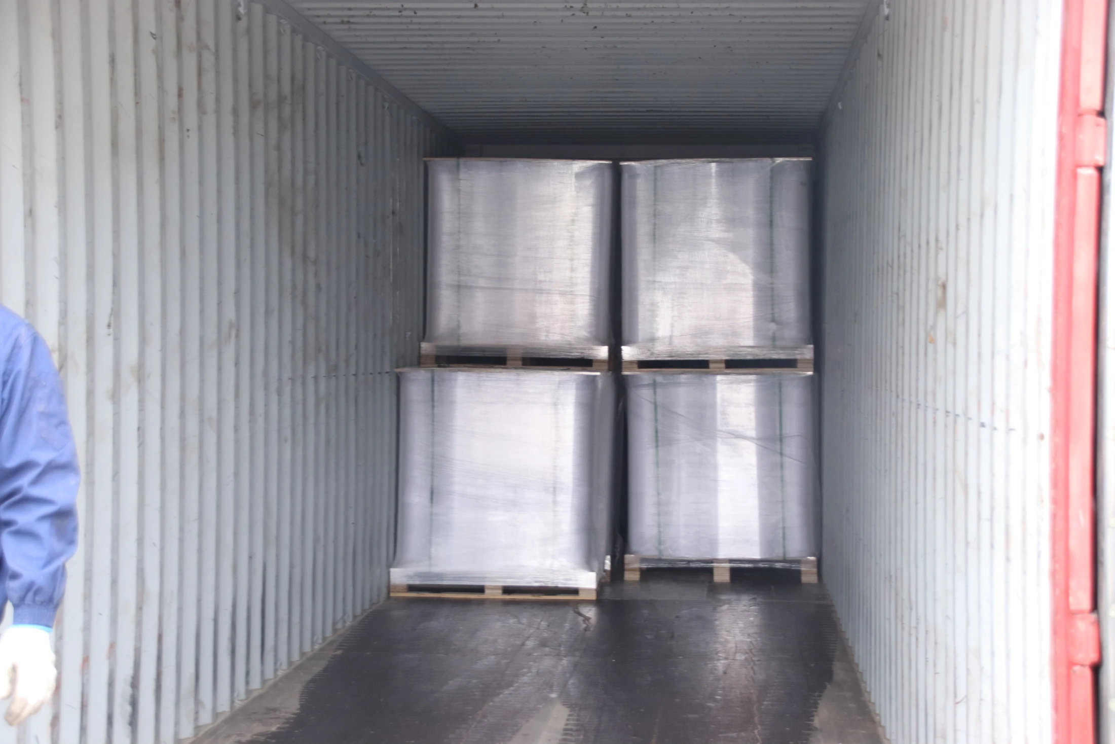 Wrapped membrane rolls secured on pallets inside a container